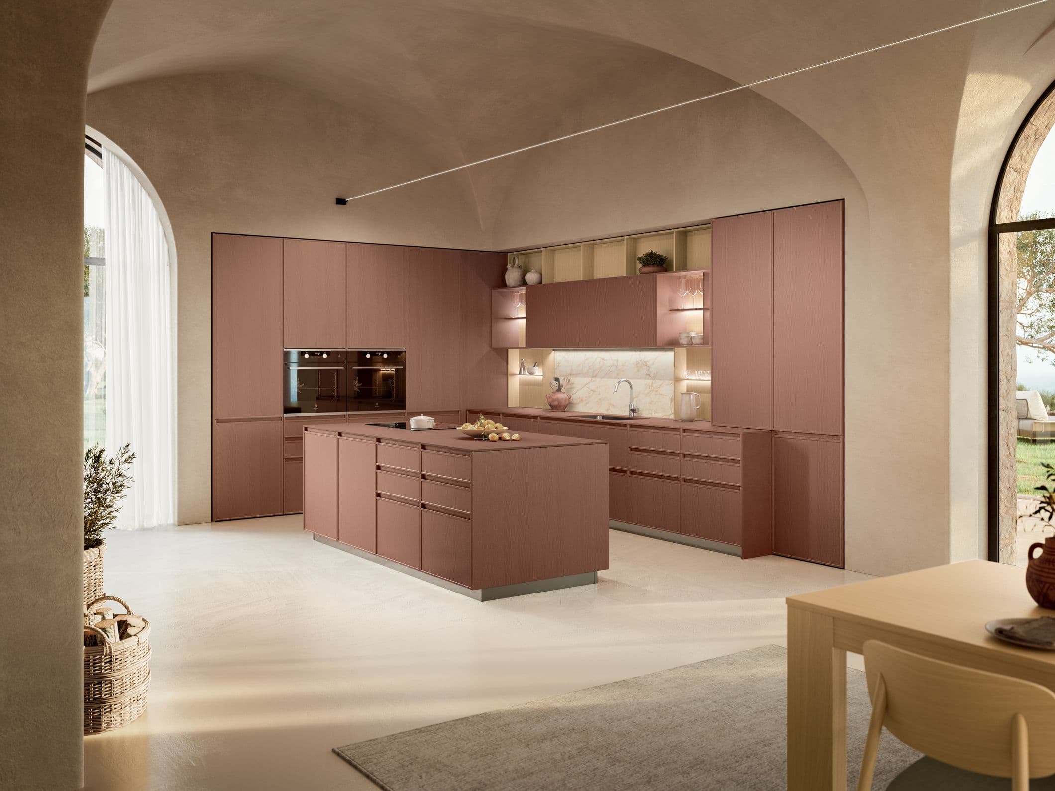 Cucina open space color terracotta con isola centrale e colonne integrate